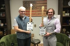 Another-shot-of-Barry-and-Devon-each-holding-a-guitar-made-by-Barry-scaled
